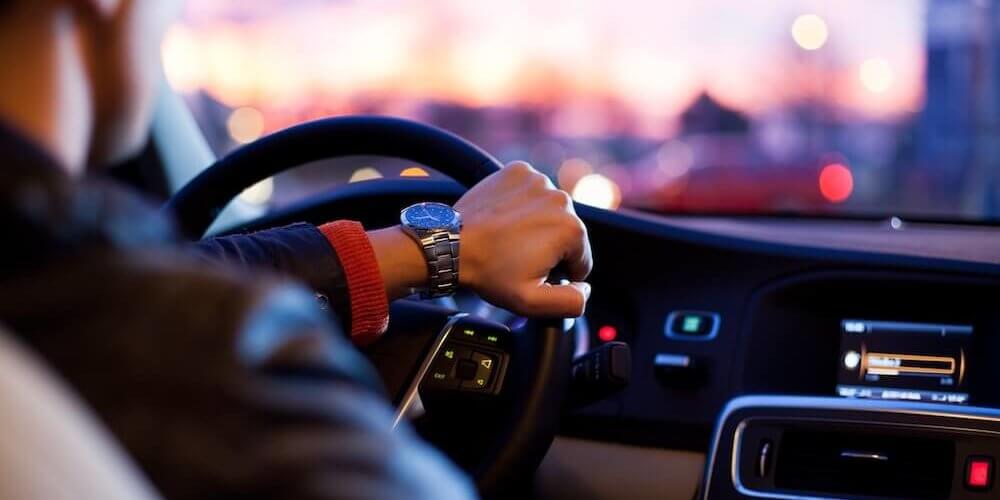 mans hand on the wheel and driving image