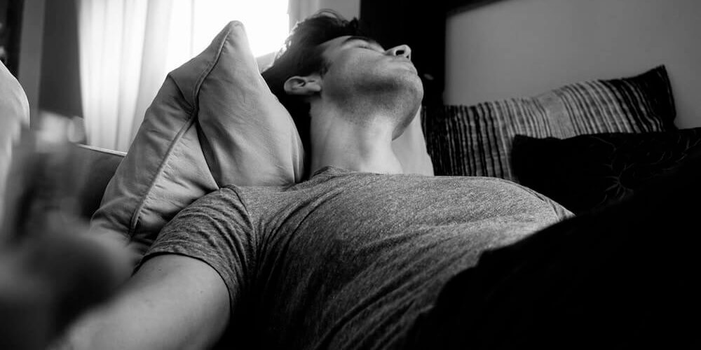 image in black and white of man sleeping