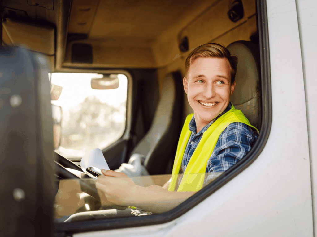 a new hgv driver sits in the cab of a c+e vehicle after passing an hgv training course